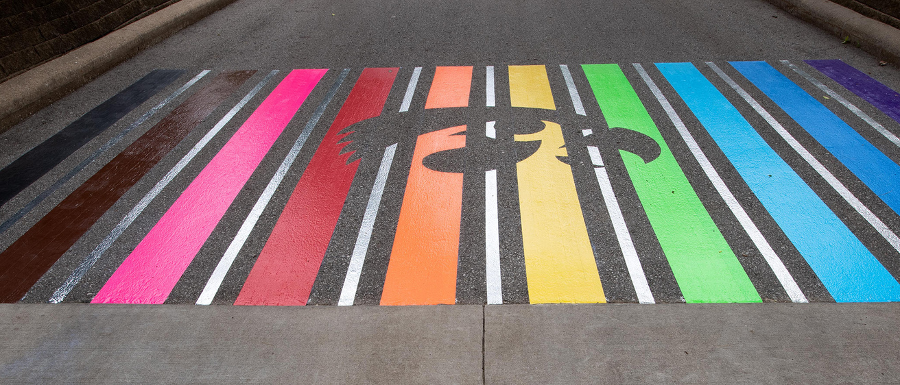 A rainbow crosswalk featuring the Tigerhawk logo